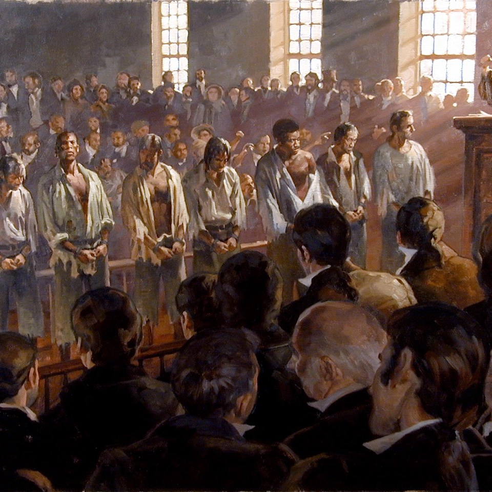 a group of people standing in front of a large crowd of people