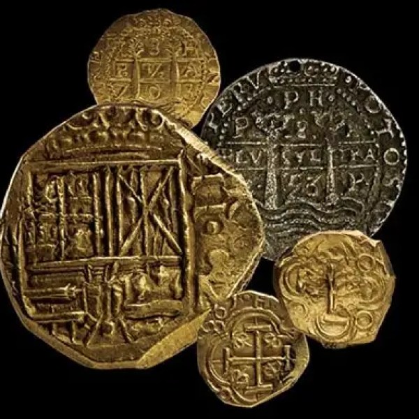 A collection of gold and silver ancient coins on a black background.